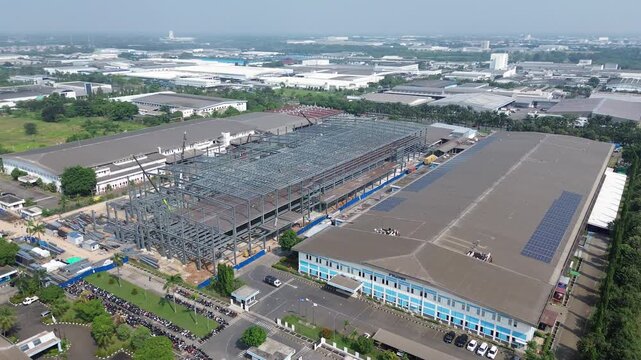 Cikarang, Indonesia - June 18, 2026: Drone view of a large factory expansion project under construction in the Cikarang industrial area