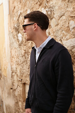 Stylish Young Man By Stone Wall