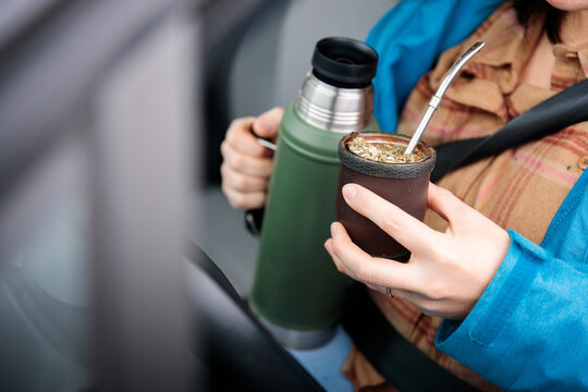 Hand holding traditional yerba mate infusion