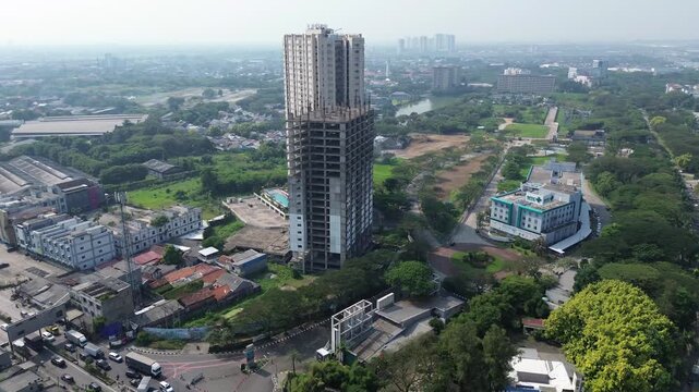 Cikarang, Indonesia - June 18, 2026: Aerial view of a high rise residential tower under construction in the rapidly developing Cikarang urban area