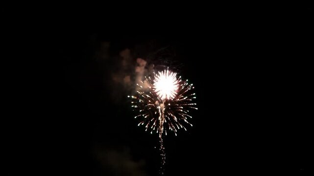 Glowing light trails in dark sky, burst pattern, fireworks display