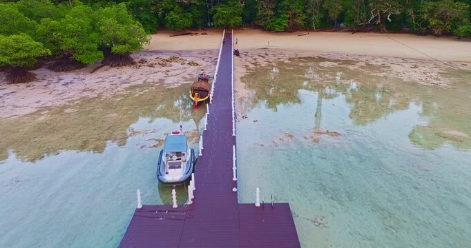 Aerial View of Coral Reef Coastline at Surin Islands in beautiful sunset. Tropical paradise landscape with white sandy shoreline, coral reef textures, and deep blue ocean surrounding Mai Ngam Beach.
