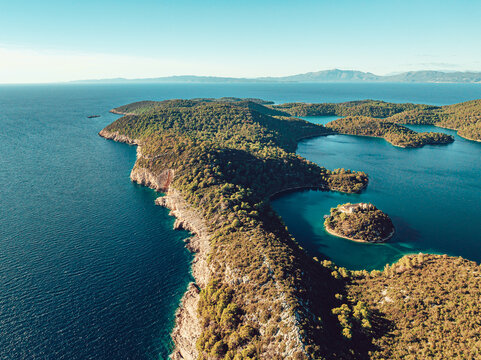 Aerial view of Mljet National Park featuring lush forests, calm blue salt lakes, and the small island of St. Mary with its historic monastery in Dubrovnik-Neretva County, Croatia.