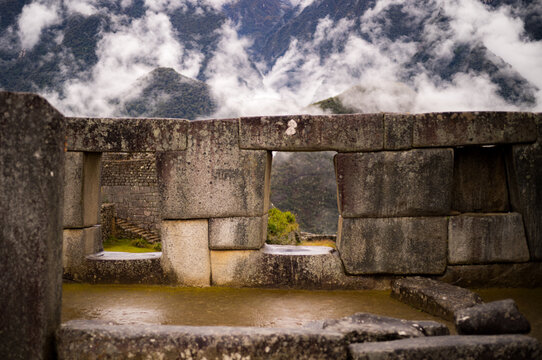 Windows in a stone wall at Machu Picchu in the Andes mountains of Peru, South America.