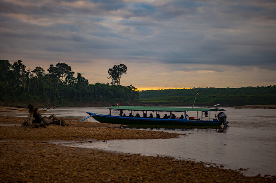 Sunrise and a boat on the Amazon river in the jungle of Peru