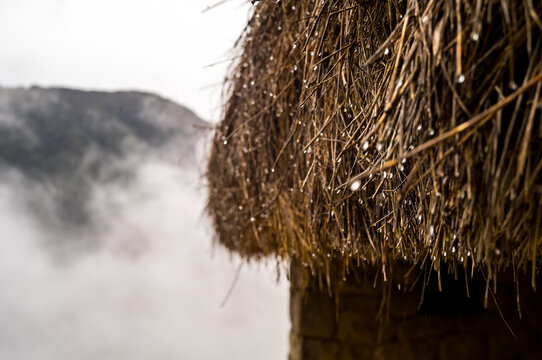 Rain on a thatch roof at the ruins of Machu Picchu in the Andes mountains of Peru, South America.