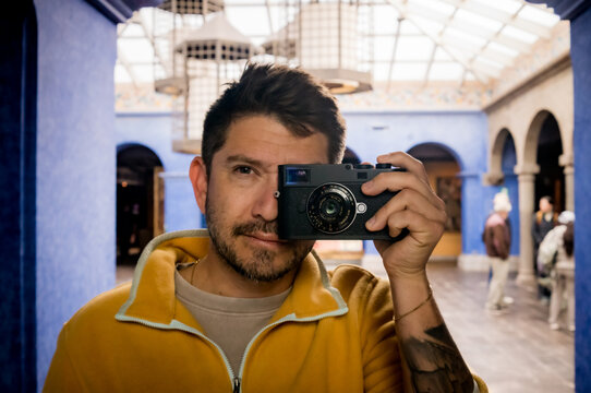A self portrait of a man and a camera in a mirror.