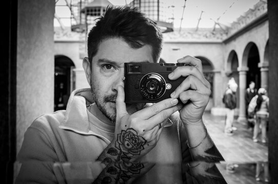 A self portrait of a man and a camera in a mirror.