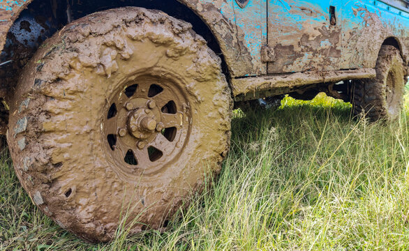 Mud-covered off-road vehicle wheel after crossing an extreme muddy track, highlighting rugged adventure driving, challenging terrain conditions, and the demanding nature of off-road activities.