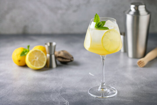 Homemade Limoncello spritz drink of liqueur, sparkling wine and lemon in Wine  glass