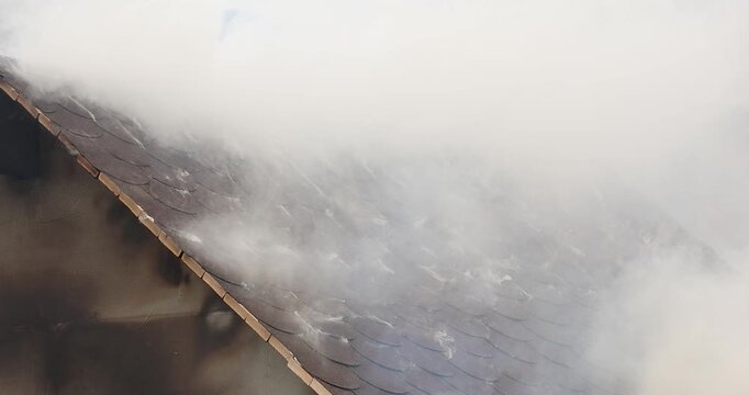 A 4K slow motion movie with a miniature house burns in a controlled manner to observe the behavior of different materials and untreated wood against fires.