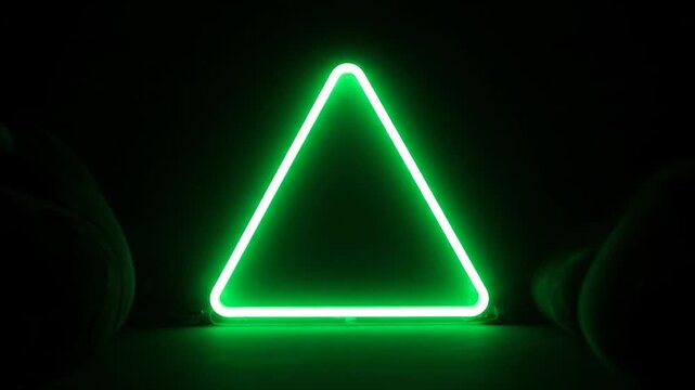 Glowing green neon triangle against a dark background, edges defined