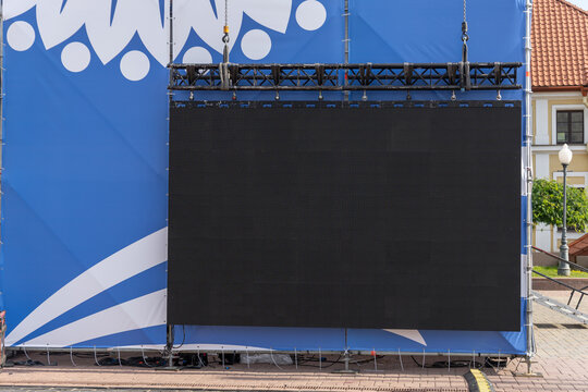 Large blank black outdoor LED display mounted on metal event truss