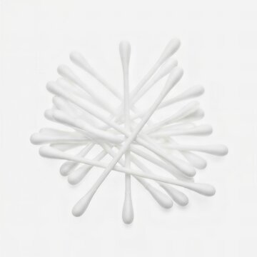 A pile of white cotton buds or q-tips isolated on a white background.