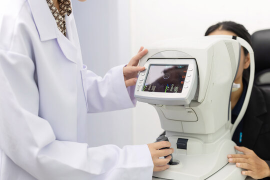 Patient receives eye exam with vision testing equipment at an optometry clinic