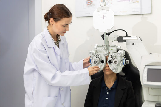 Patient receives eye exam with vision testing equipment at an optometry clinic