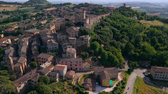 Offagna Marche Italy 4K Aerial. Drone flight along fortress walls of one of most beautiful villages of Italy. Authentic medieval borgo townscape on rolling green hills background. Hidden gems