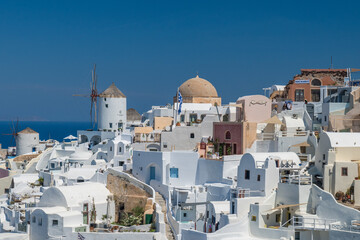 Sunlit Cycladic architecture on Santorini overlooking the Aegean Sea, Greece. © Andrei Tomas