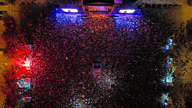 Aerial top view of crowd people at night music concert