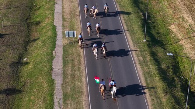 Desfile de jinetes a caballo recorriendo Urdinarrain, Entre R&iacute;os, durante la Fiesta Provincial del Caballo en un d&iacute;a soleado