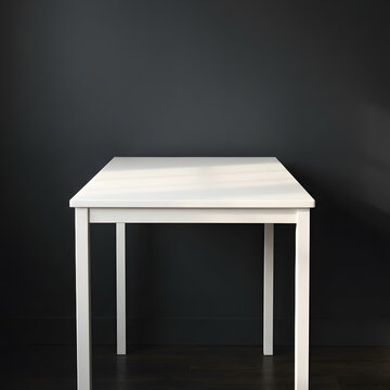 Modern minimalist white round pedestal table in dark setting.