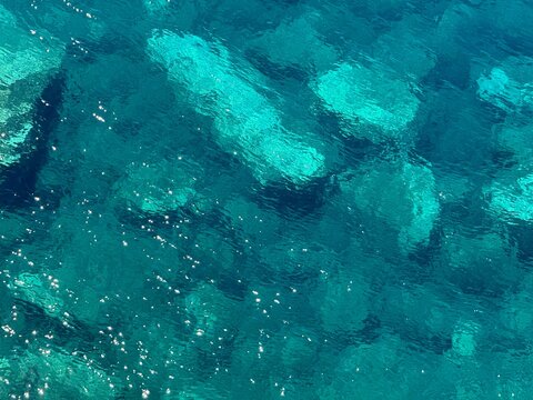 Blue azure sea beautiful clear water with sparkles on surface.