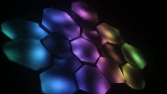 Glowing hexagonal shapes with a gradient of blue, teal, green, and purple
