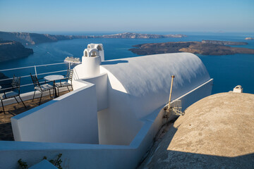 Bright blue Aegean Sea view from Oia with white cycladic architecture and volcanic islands in the distance. © Andrei Tomas