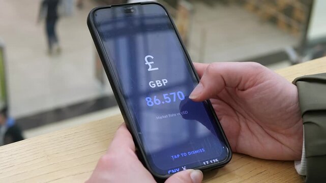 User scrolling through a comprehensive World Rates list on a mobile app. EUR, GBP, and JPY values clearly displayed for global market analysis. Ideal for international finance, foreign exchange, and