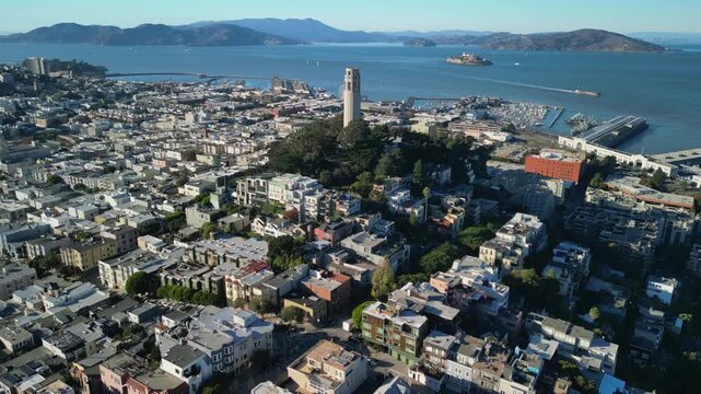 Cinematic drone footage orbiting around Coit Tower on Telegraph Hill in San Francisco. Smooth aerial movement showcasing the iconic Art Deco landmark.