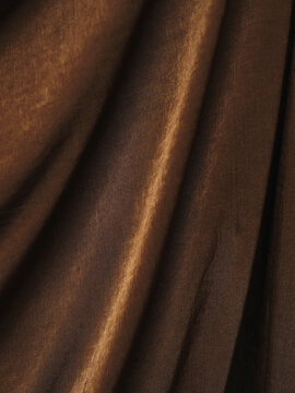 Colorful fabric with textured weave and soft folds. Luxurious velvet or silk surface catches light. Perfect for fashion, interior design, or luxury branding. Can be used in product shots, catalogs