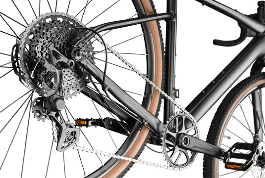 Detailed close-up of a modern gravel bicycle drivetrain. Multi-speed cassette, rear derailleur, chain and crankset isolated on white background.