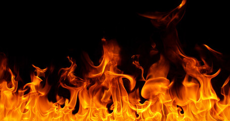 Fototapeta premium Burning orange flames with glowing embers isolated on black background. Realistic fire effect suitable for visual effects, compositing, motion graphics and video editing.