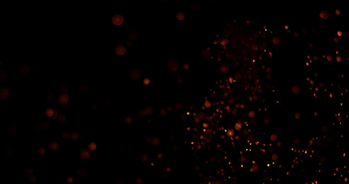 Glowing embers and fire particles drifting through dark background. Atmospheric cinematic effect ideal for compositing, motion graphics, visual effects and video production.