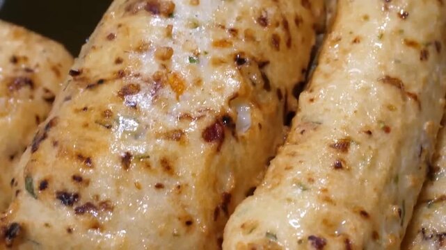 High-quality footage showcasing a variety of golden-brown Korean fish cakes, also known as eomuk or odeng. The clip highlights the chewy texture and savory appeal of this iconic South Korean street fo