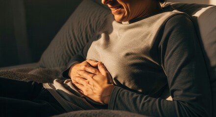 Fototapeta premium Woman Suffering From Stomach Pain Clutching Her Abdomen In Discomfort