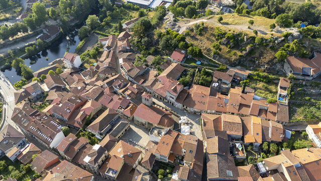 Aerial view of the historic town of Allariz featuring terracotta rooftops, narrow streets, a central square, and the Arnoia river in Allariz, Province of Ourense, Spain.