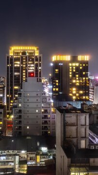 Time Lapse of the buildings in downtown Kaohsiung in southern Taiwan at night. Vertical video.