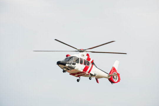 Red and White Emergency Helicopter Airborne in Clear Blue Sky, The Concept of Medical Evacuation