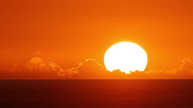 Time lapse of the sun setting over the ocean in Hawaii.