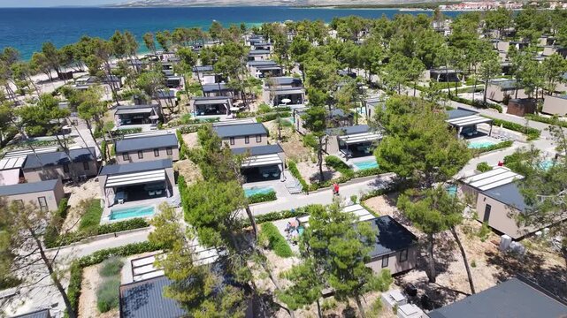 Drone footage of Camp Rastovac in Povljana showing numerous holiday homes surrounded by Mediterranean landscape on Pag Island