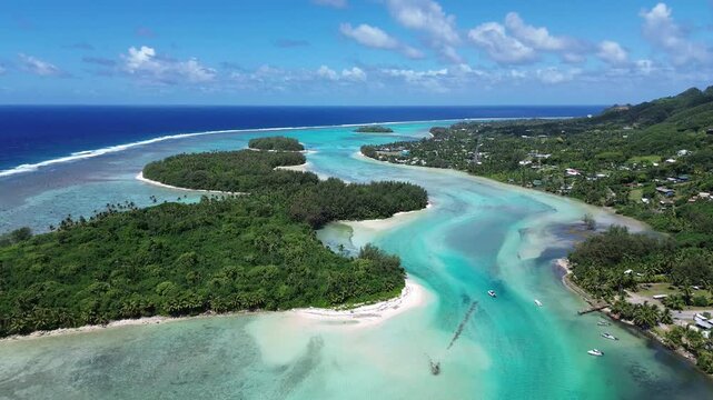 A drone view of Rarotonga,Muri Beach. the capital of the Cook Islands.Beautiful ocean view of coastline with clear water and houses in the sun