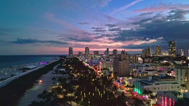 Miami beach iconic night skyline. Miami aerial panorama coastline. Miami south pointe shore dusk. Miami Ocean drive waterfront evening.