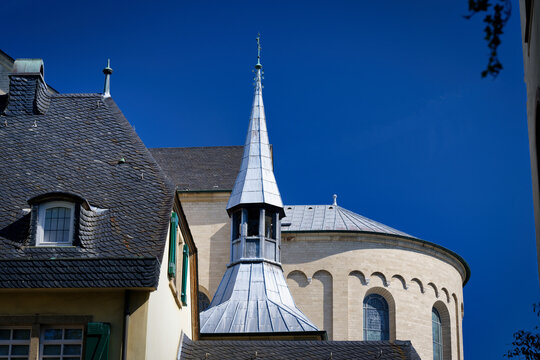 Architectural detail of St. Maria im Kapitol, Cologne, Germany. View of the steeple and the Romanesque apse under a clear blue sky.