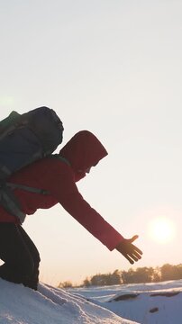 silhouette people climbers going forward mountain sunset. concept climbers with backpacks. teamwork. family trip mountains with backpacks winter sunset. campaign young successful winners. help hand