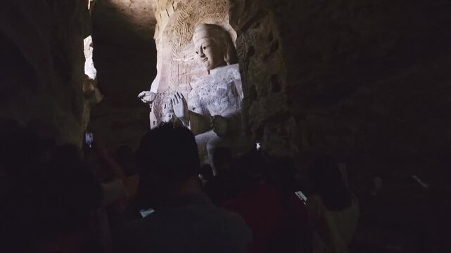 Yungang, China - May 9 2026: Majestic Buddha statue in the Yungang Grottoes, embodying spiritual serenity, monumental artistry, and the rich heritage of ancient Chinese Buddhist culture