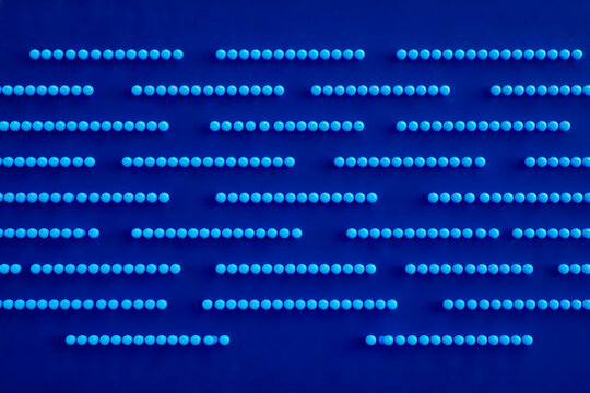 A structured array of dense blue circular LED light emitters arranged in parallel horizontal rows on a dark blue background.
