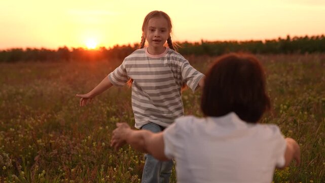 Mother and daughter reunion at sunset, Joyful embrace in the field, Child running into open arms, Family love in nature, Warm evening hugs, Innocent childhood moments, Emotional family connection