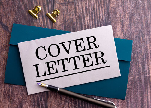 Cover Letter Concept with Envelope and Fountain Pen on Wooden Desk.