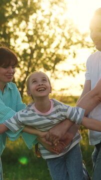 Parents swinging child daughter swing, child kid dreaming airplane pilot, happy girl face sunlight, mother father playing girl sunset, imaginative child play, family holding hands, weekend relaxation